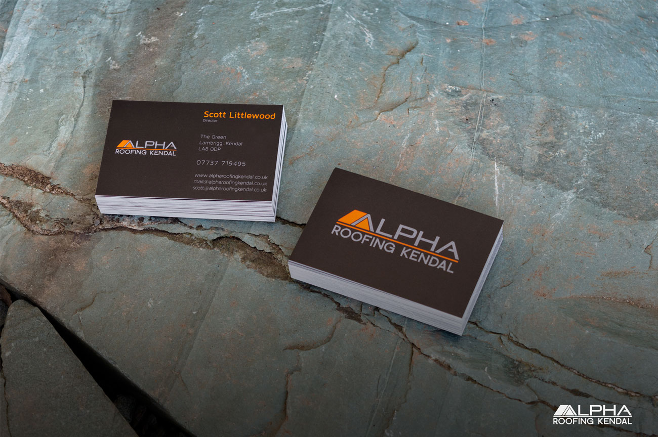 Alpha roofing kendal's business cards displayes on a piece of slate