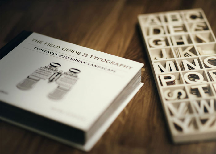 A book of typography next to a font full of letters