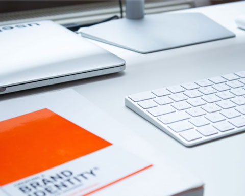 A book on a desk, titled brand identity